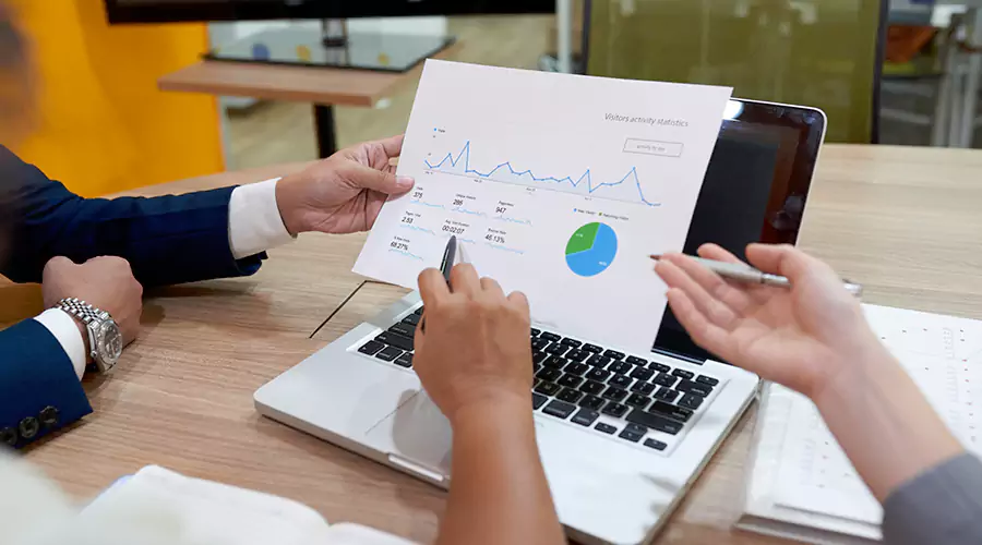 Alt Text: Professional lawyers networking at a local seminar, shaking hands and exchanging business cards in a well-lit event space, representing effective strategies for attracting new lawyer clients and building professional relationships.