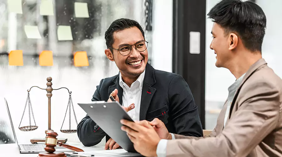 Lawyer Clients shaking hands with happy client representing referral and trust depicting How to Find Clients as a Lawyer